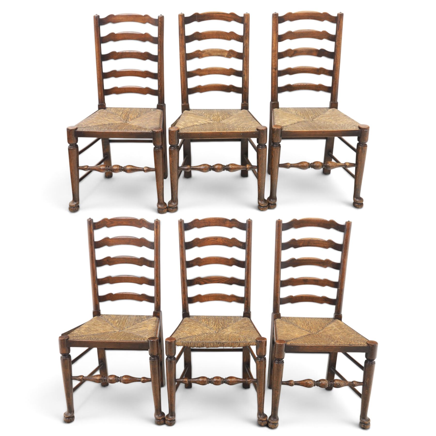 19th century set of six ash and elm ladderback dining chairs, shaped ladder backs above rush seats, raised on turned front supports with pad feet, united by turned stretchers
