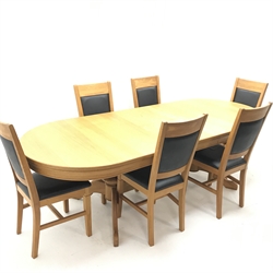 Oval solid oak extending dining table,  two turned columns on shaped supports joined by stretcher (W200cm and 250cm, H68cm, D101cm) and six oak framed chairs, upholstered back and seat (W44cm)