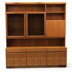 McIntosh Furniture - mid-20th century teak highboard unit, two glazed cupboards enclosing a glass shelved interior, a fall front cabinet to the other side mirrored back, with three frieze drawers one fitted for cutlery, with applied square panels