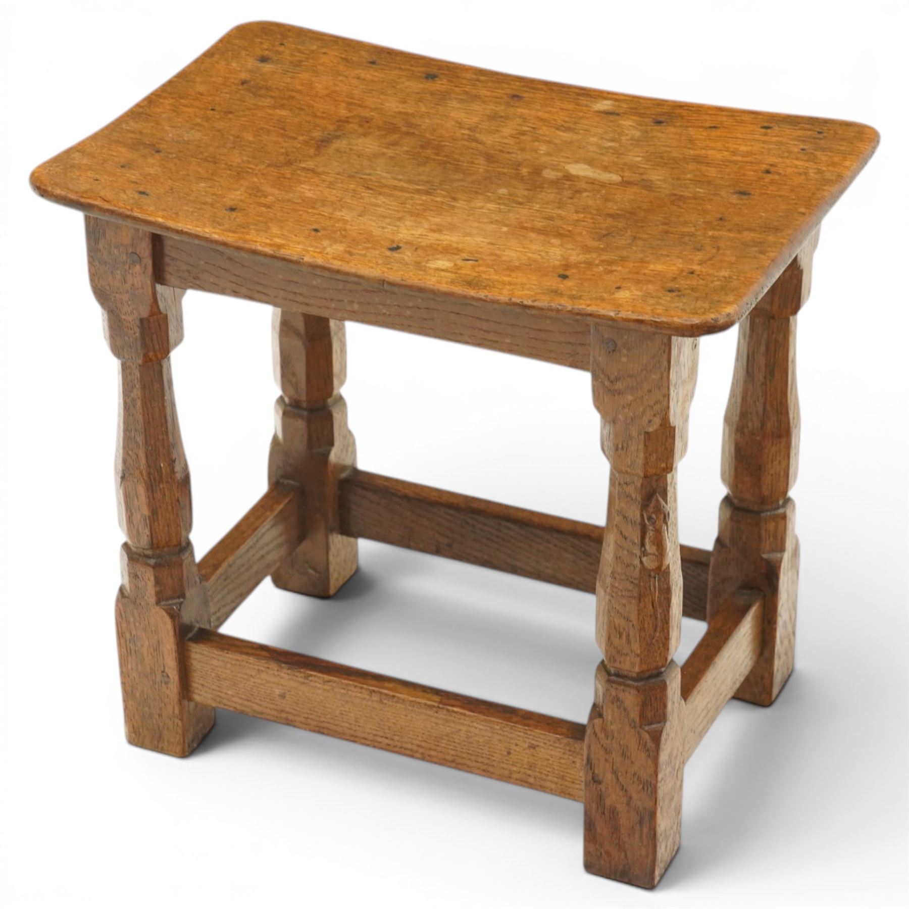 Mouseman - mid-20th century adzed oak joint stool, dished oak seat, on shaped octagonal supports joined by box stretcher, with carved mouse signature, by the workshop of Robert Thompson of Kilburn
