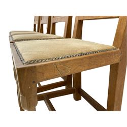 'Eagleman' set four oak dining chairs, adzed panelled backs, upholstered seats with stud work band, the side rails relief carved with inset eagle signature, shaped octagonal supports joined by stretchers, by Albert Jeffray of Sessay, Thirsk