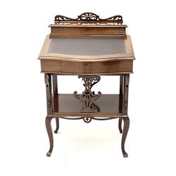 Early 20th century mahogany davenport, raised shaped and pierced back, hinged sloping top enclosing two drawers, four supports joined by solid undertier on cabriole legs