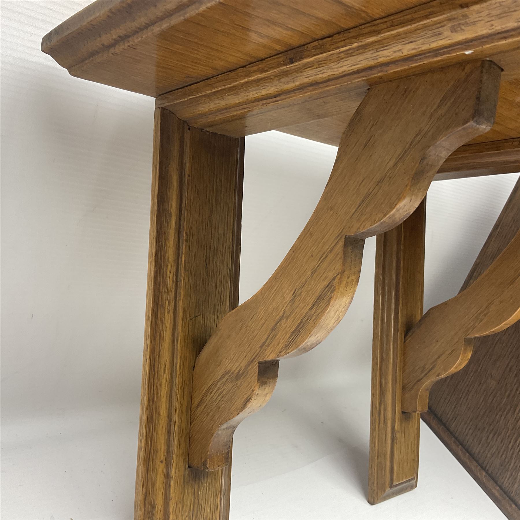 Early 20th century oak smokers cabinet, with brass shield shaped mounts, opening to reveal a compartmentalised interior with three drawers, pipe rack and tobacco jar, together with a small wooden shelf, smokers cabinet H28.5cm
