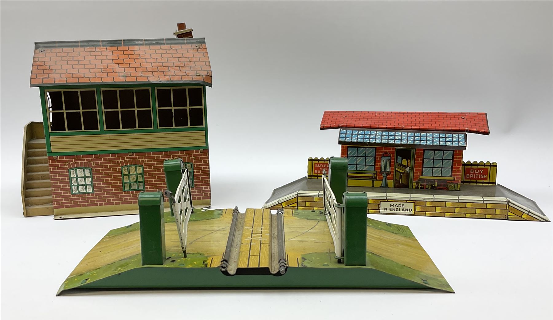 Hornby '0' gauge - layout accessories comprising PR1/PL1 Points, CR1 Right Angle Crossing and CA2 Acute Angle Crossing, all boxed; tin-plate signal box; tin-plate level crossing; textured wooden tunnel, possibly pre-WW2; and quantity of track, some boxed; together with '00' gauge tin-plate station