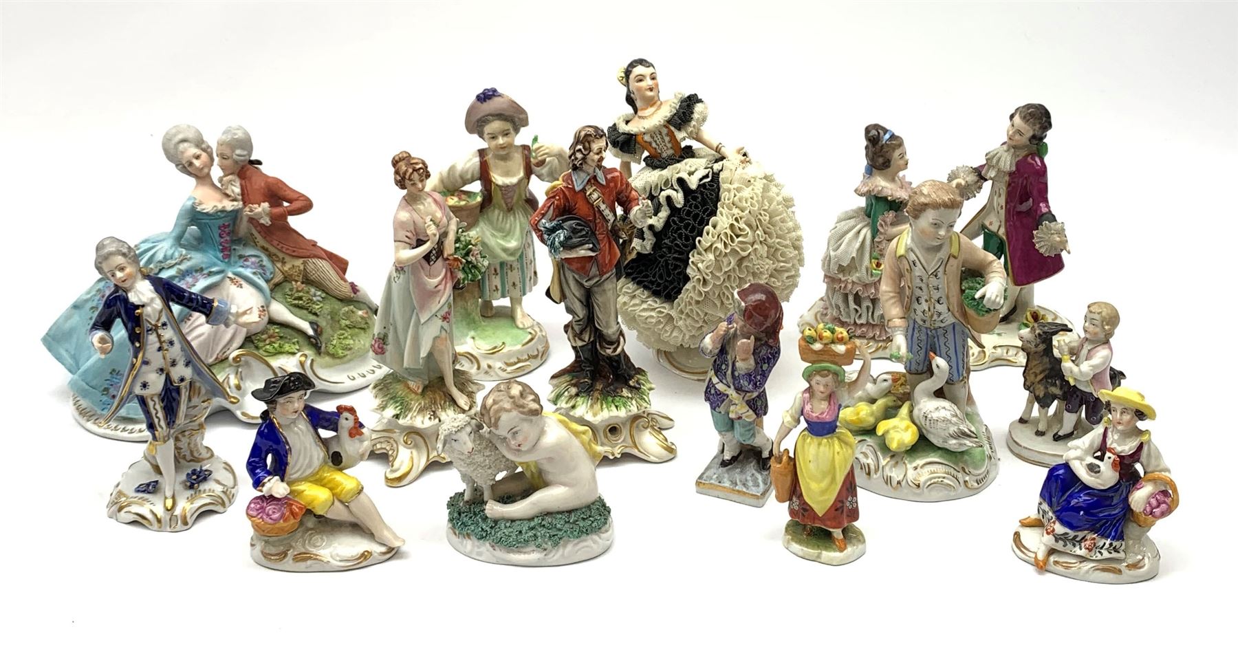 A group of various Continental figures, to include examples marked Dresden and Capodimonte, plus others with spurious blue cross marks beneath. (14). 