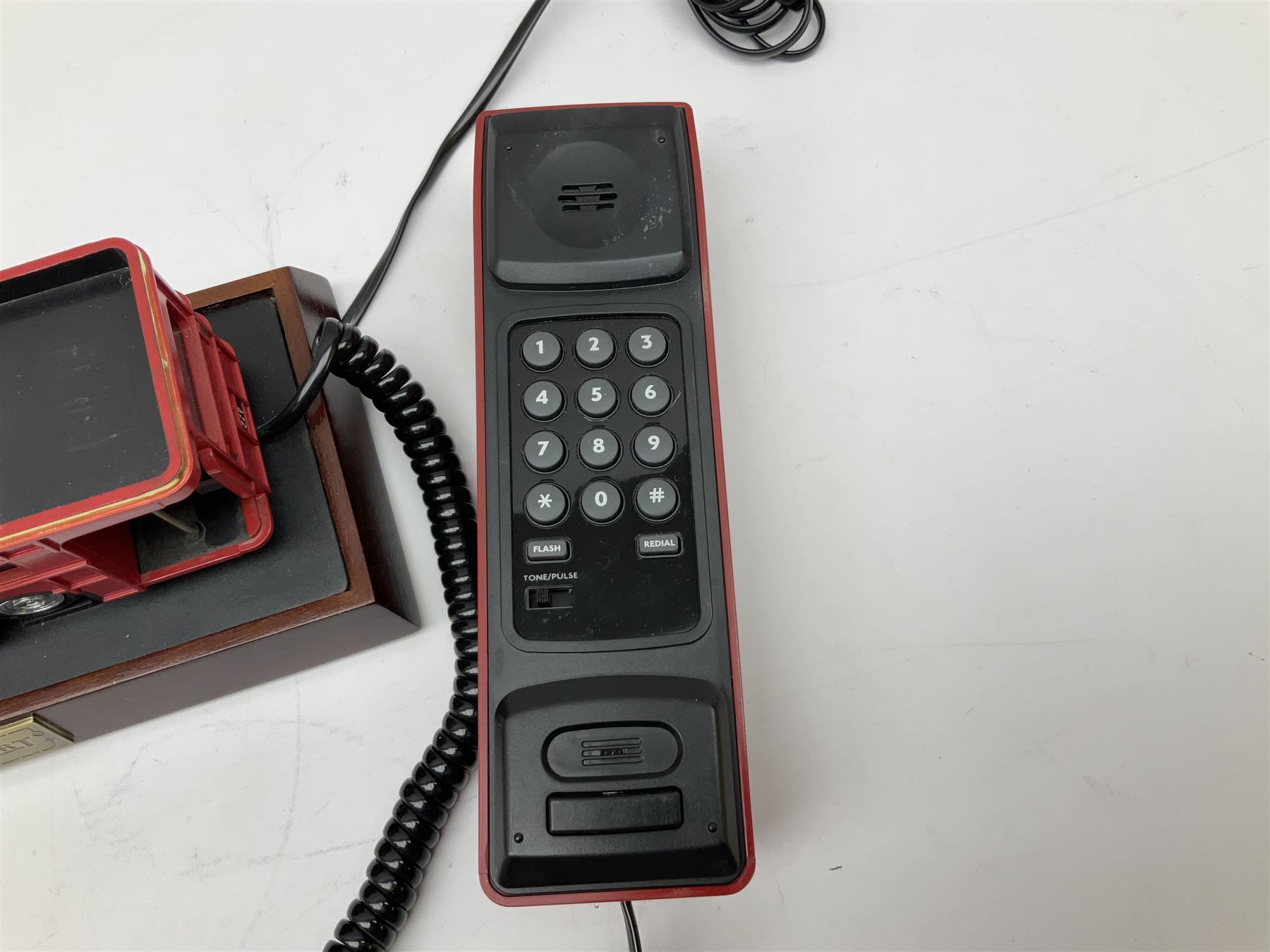 Novelty telephone in the form of a London Routemaster bus, c1997, fitted on wooden plinth with modern connection L25.5cm
