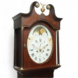 Rea of Walton on Trent (Derbyshire)-8-day Oak cased Longcase clock c1810, case with a swan necked pediment, brass parterre and a ball and eagle brass finial, bespoke hood door flanked by reeded pilasters with brass capitals, trunk with conforming recessed quarter columns and twin spire topped door, on a square plinth with canted corners and an optional detached base, comparatively rare painted oval dial with gesso decorated spandrels and a moon dial to the arch, chapter with Roman numerals, minute markers and Arabic quarter minutes, matching stamped brass hands with a subsidiary seconds dial and date aperture, dial pinned via an 