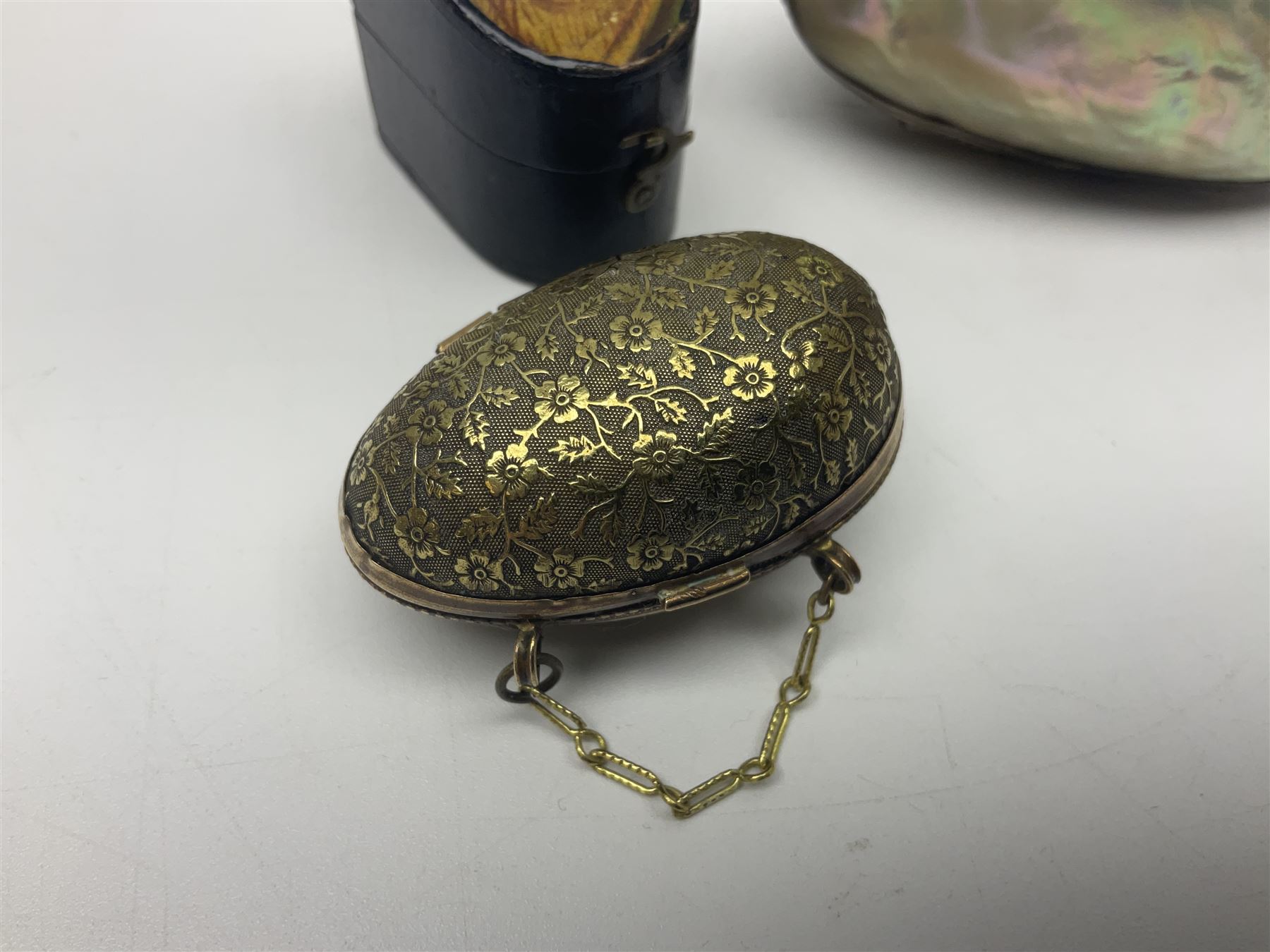 19th century lacquer thimble case with painted portrait of a woman to the hinged lid, together with two mother of pearl egg shaped thimble cases and one other