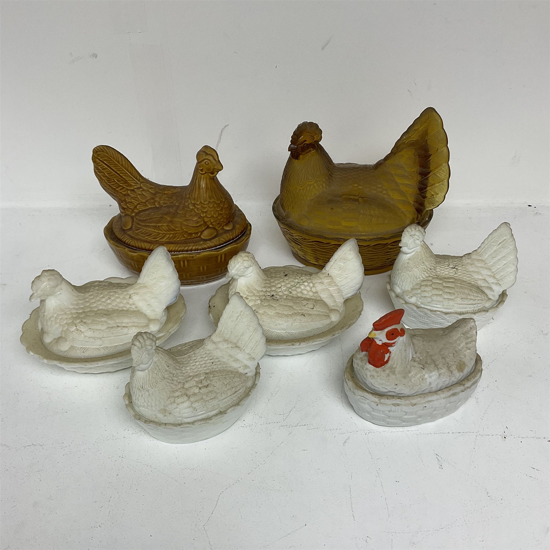 Seven Hen on Nests, to include milk glass examples, largest H22cm 