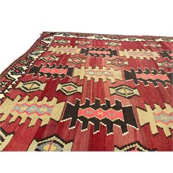 Large  red ground Kilim rug or wall hanging, decorated with geometric patterns and dated within the weave '1969'
