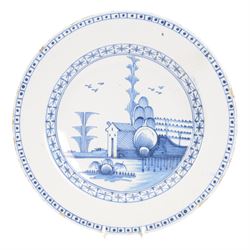Mid 18th century Lambeth Delft plate, probably from the Abigail Griffith factory, circa 1750, painted in polychrome enamels with a figure seated in a landscape, within a garlanded border of flowers to rim, D34cm, together with a Liverpool Delft plate, circa 1760, painted in blue with a boathouse surrounded by trees by a river, within diaper and cell borders, D37cm