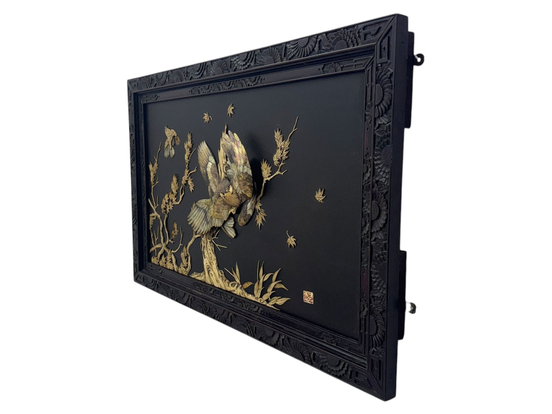 Meiji period (1868–1912), signed Shibayama carved hardwood lacquer panel inlaid with mother-of-pearl and ivory, decorated in high relief and inlaid, depicting two birds of prey with locked talons and beaks on leafy tree branch, signature in lower right corner, in original frame. This item has been registered for sale under section 10 of the APHA Ivory Act