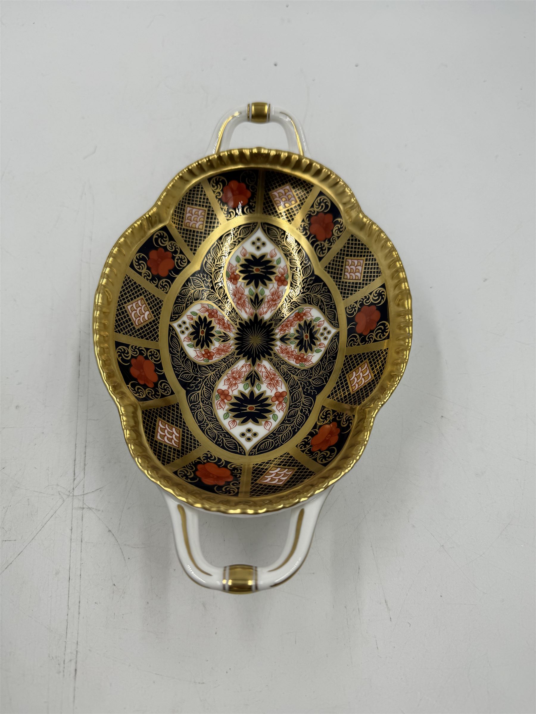 Royal Crown Derby Old Imari pattern 1128 twin handled sweetmeat dish, upon an oval pedestal, with printed mark beneath, H4.5cm, including handles W22.5cm 