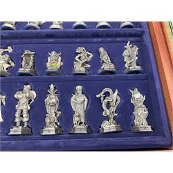 Danbury Mint 'The Fantasy of the Crystal' chess set consisting of mythical pewter chess pieces within a wooden case with chess board lid, together with 16 additional chess pieces in a wooden display case.