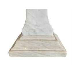 Classical Grecian design Carrera marble centre table, the rectangular single slab top with rounded corners and carved edge, raised on twin pedestals comprised of three pieces with a waisted column on a stepped plinth