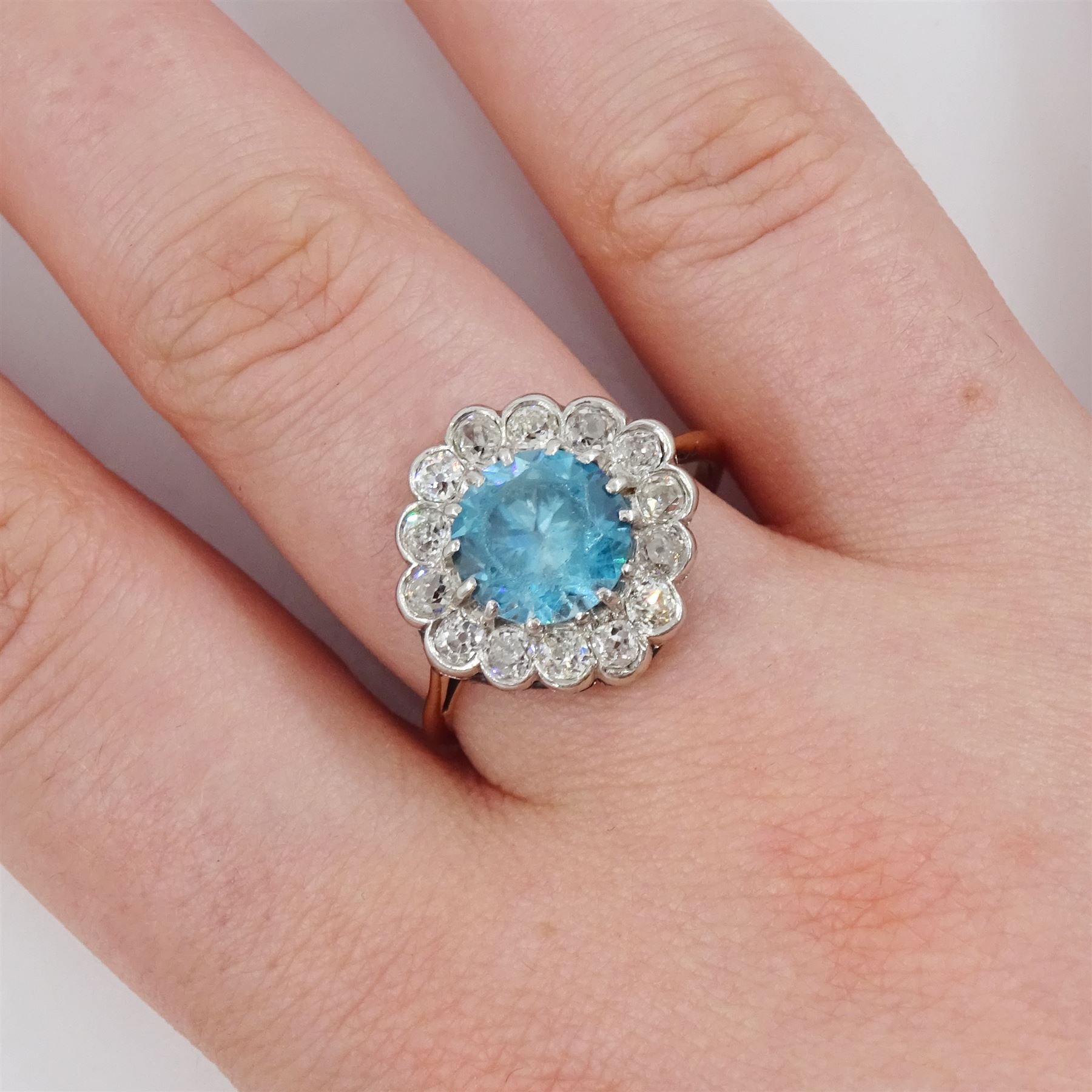Early 20th century 18ct gold round cut blue zircon and old cut diamond cluster ring, zircon approx 3.35 carat, total diamond weight approx 1.10 carat