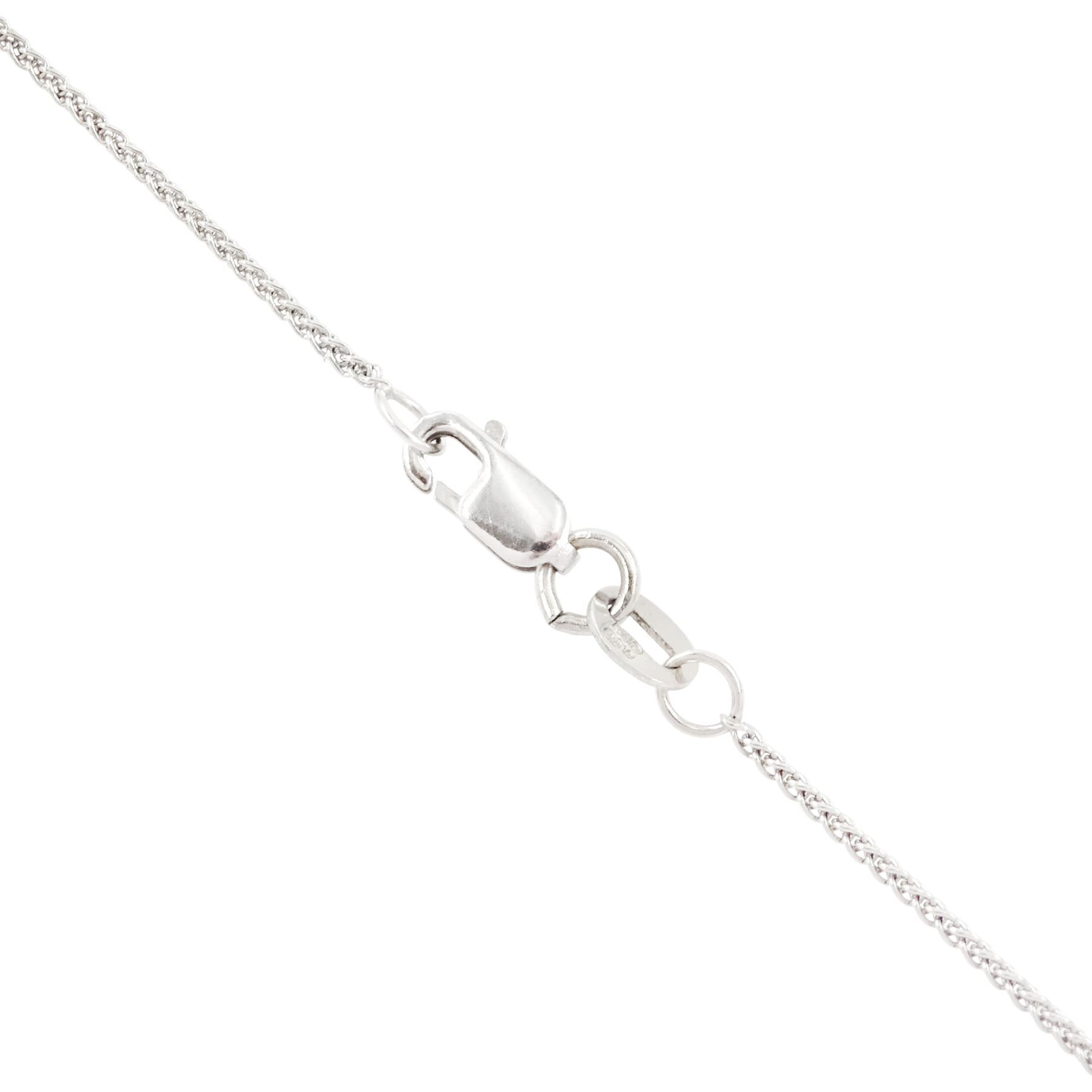 Early 20th century platinum and 18ct yellow gold ruby and diamond circular pendant, single old cut diamond of approx 0.25 carat, within a milgrain pierced fancy foliate surround, set with single cut diamonds, to a navette shaped border set with alternate calibre cut rubies and rose cut diamonds, each spaced by a single old cut diamond, suspending a pearl and diamond drop, on a later 18ct white gold wheat link chain necklace, hallmarked