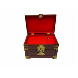 Chinese hardwood jewellery box mounted with engraved brass fixtures, the two exterior doors revealing three drawers below the hinged upper lid, lined with red material decorated with floral sprays, H25cm, W36cm, D23cm