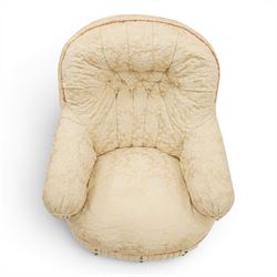 Victorian button-back nursing chair, the rounded horseshoe back enclosing a deep upholstered seat, padded arms and sprung seat in cream floral damask fabric, with crimson piping and tasselled lower fringe, on turned front legs with castors