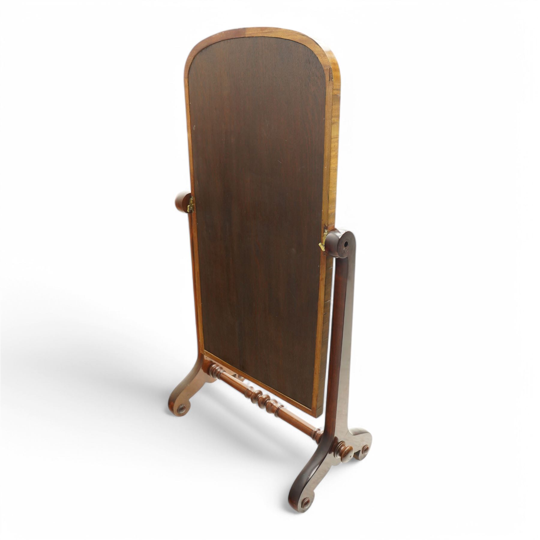 Early 19th century mahogany cheval dressing mirror, plain mirror plate within chamfered frame with arched top, on rolled horns and out-splayed rolled feet, united by turned stretcher 