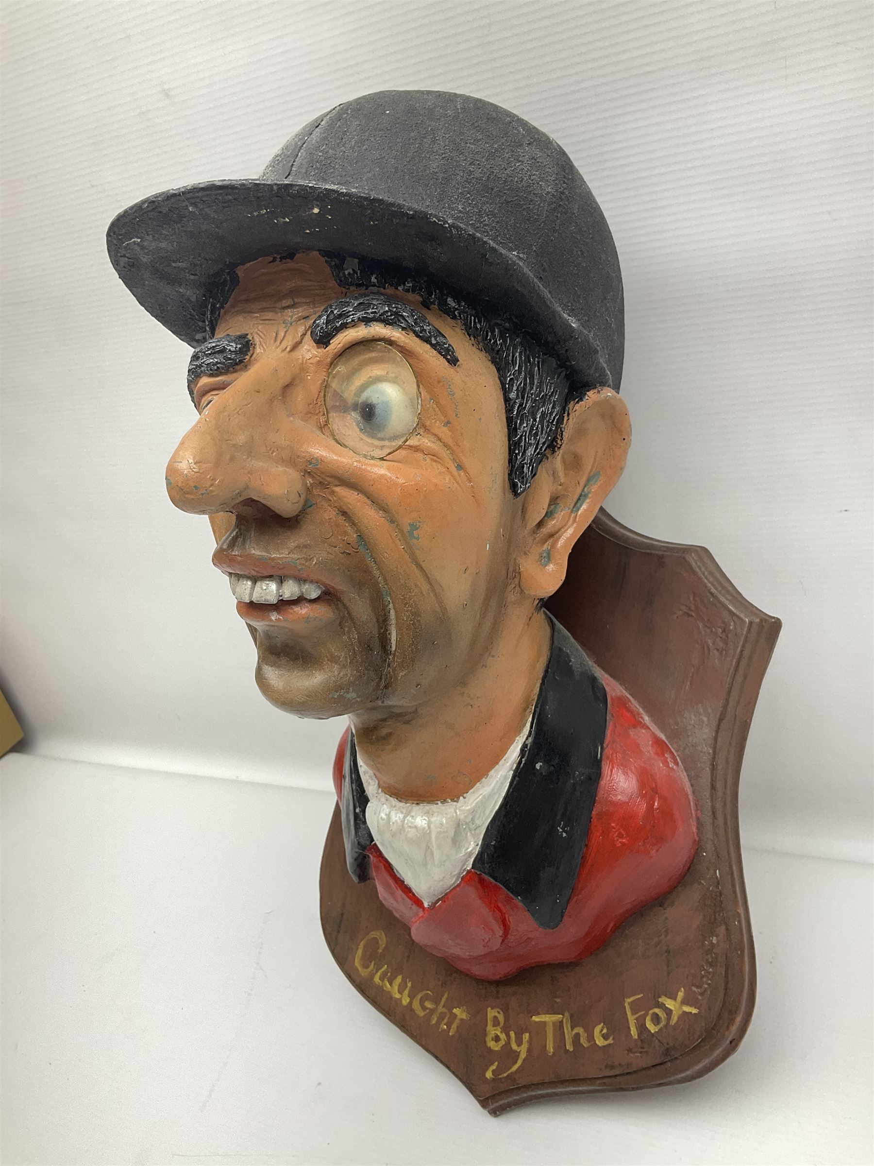 Composite figure of the head of a huntsman on a shield 'Caught by the Fox', D28cm