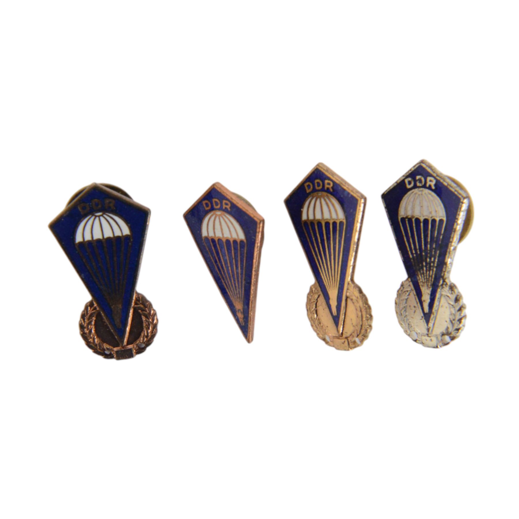 Collection of East German army parachutist metal insignia
