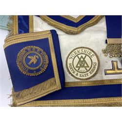 Two Masonic kid leather aprons, one with sash and cuffs, the other with sash, each marked 'Yorkshire North and East Ridings'; and three other unmarked Masonic aprons with sashes