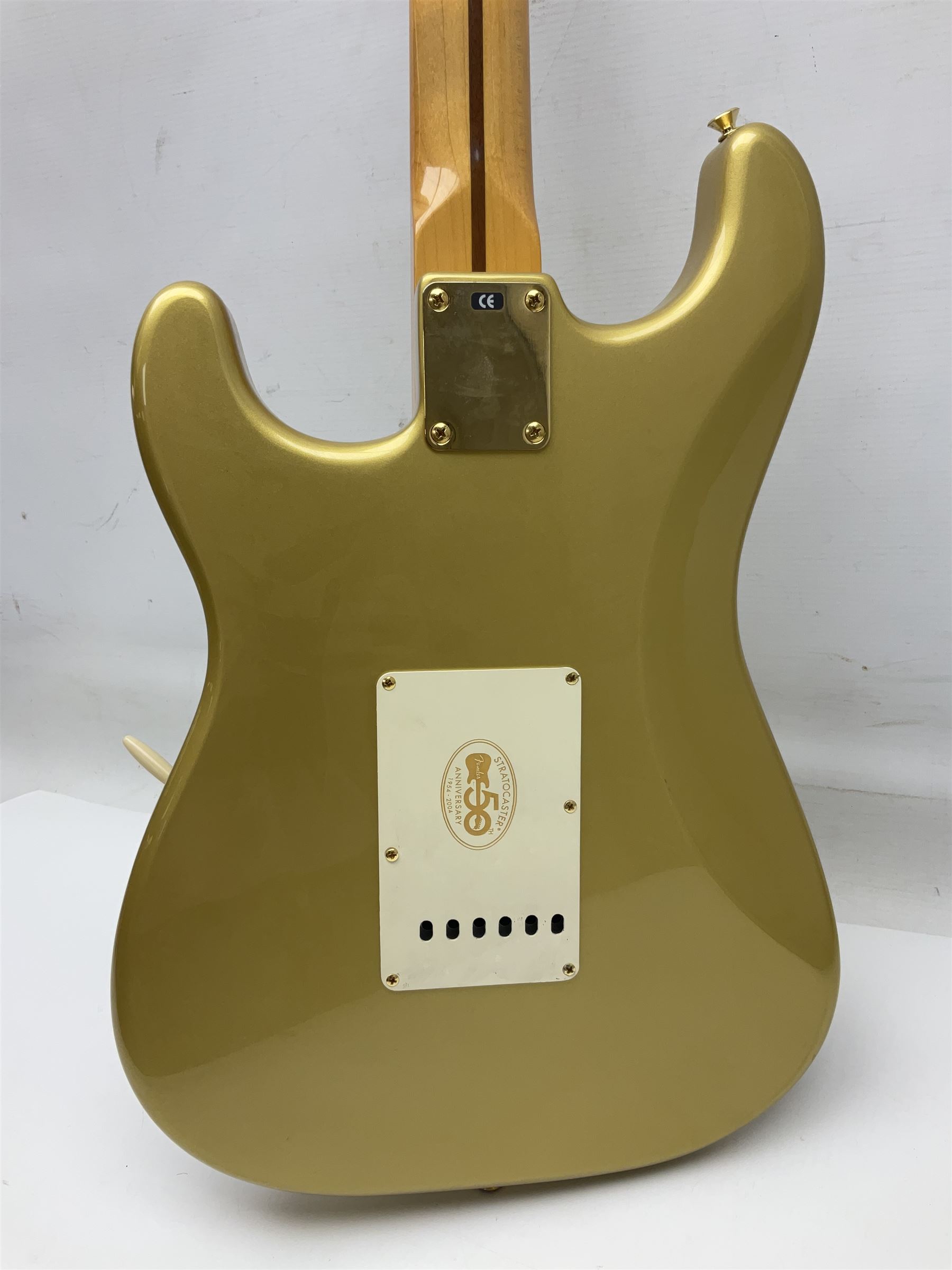 Fender Stratocaster 50th Anniversary 2004 metallic gold electric guitar; serial no.MZ4116369; L98cm; in Spider fitted case with owners manual and other paperwork, strap and belt buckle etc