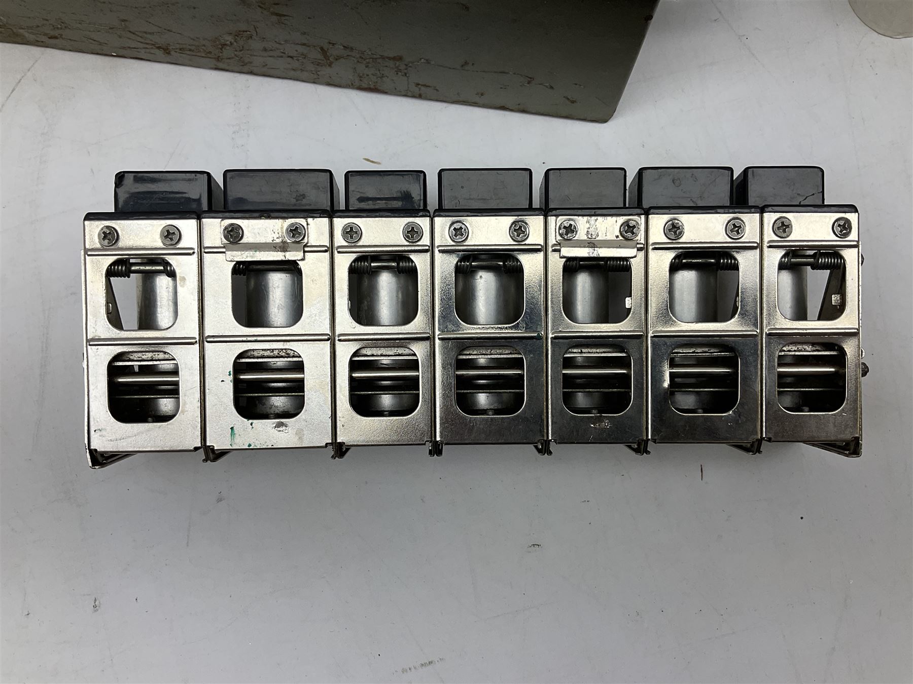 Bell Punch Company of London 'The Ultimate' five lever fare collection machine, together with an Almex ticket machine with shoulder strap, two brass Halifax transport cap badges, other chrome tramway cap badges, etc