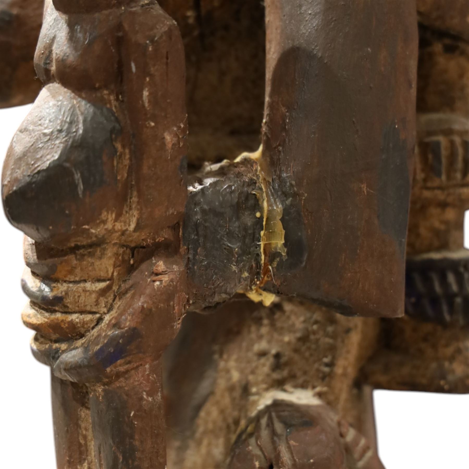 African tribal maternity figure of a woman with children, probably Yoruba, carved wood, the woman stood upon a craved mask, H133cm