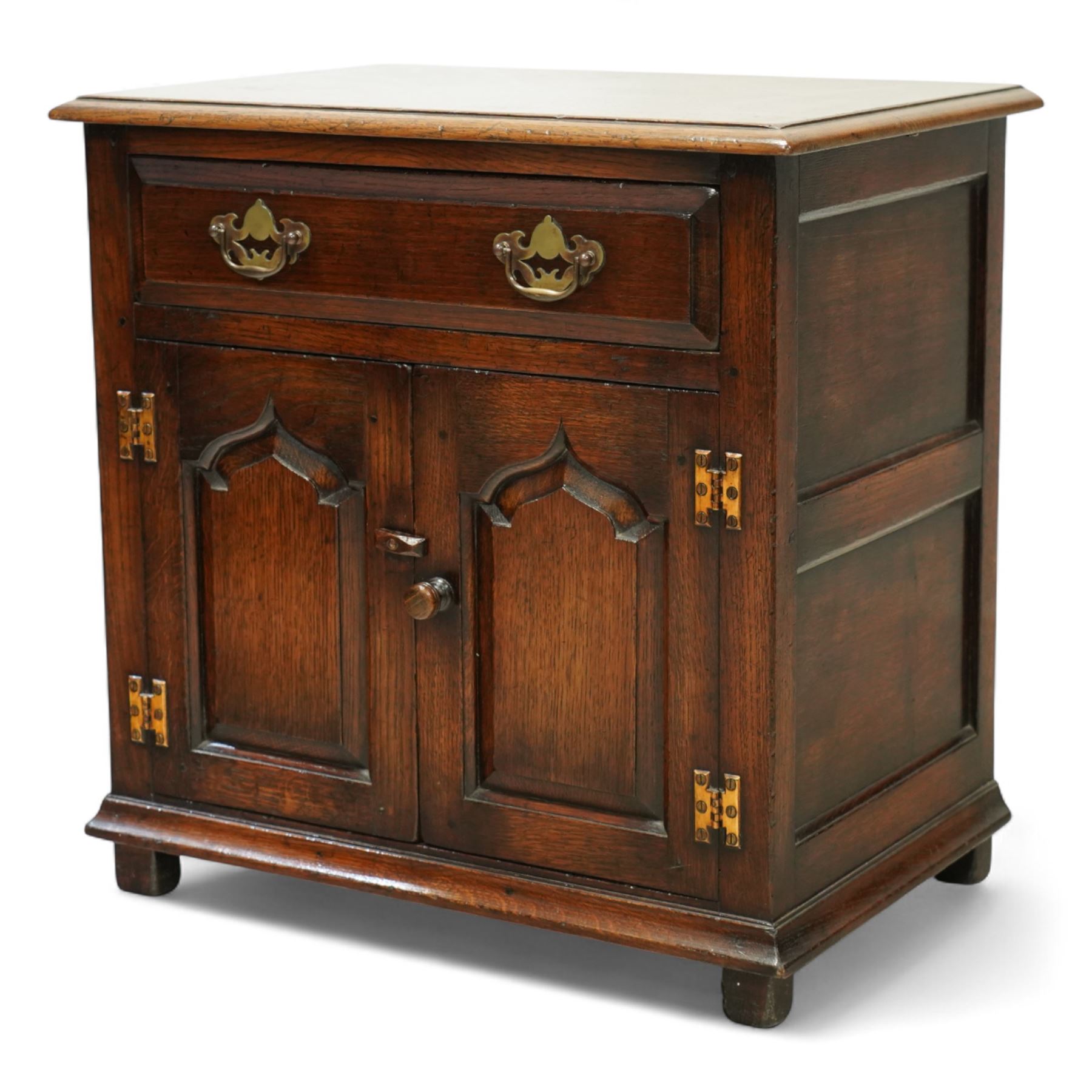 Titchmarsh & Goodwin - small oak side cupboard, moulded rectangular top over single drawer and double cupboard, stepped and pointed arched panelled doors, raised on stile feet 
