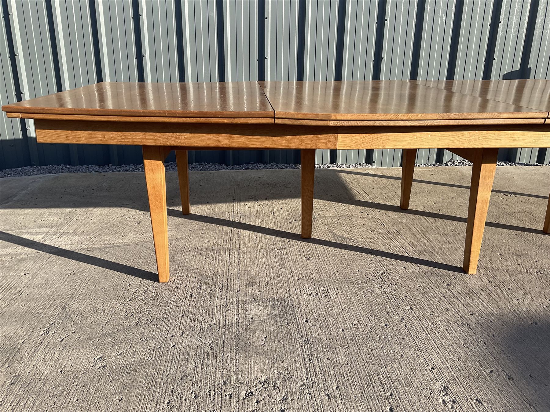 Light oak bespoke boardroom table, concave form, four sectional top on square discreet legs (12' x 5'), with twelve armchairs including 'Chairmans' chair