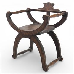 Late 19th century Savonarola style oak chair, X-frame construction with carved and shaped cresting rail, the curved arms with chip carved decoration, turned horizontal supports, solid dished seat with adzed surface, raised on shaped splayed feet
