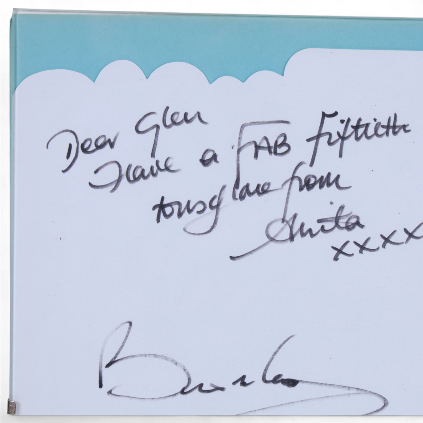 Birthday card and postcard, each signed by Brian May and Anita Dobson, with a personalised Anita Dobson compliment slip dated 2008, in glass frame