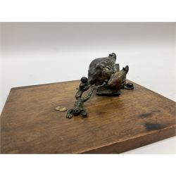 Austrian cold painted bronze note holder, the sprung loaded clamp in the form of two ducks holding a frog, on an oak base, clasp L12.5cm