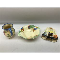 Group of Art Deco ceramics, comprising Wadeheath jug painted in spiralled bands of blue, orange, yellow and brown, shape no. 707784, Royal Doulton Caprice pattern twin handled bowl, no. D5358, Arthur Wood wall pocket of typical stylised fan form with painted floral decoration, Arthur Wood vase of cornucopia form with red and grey floral decoration, Wadeheath jug of ribbed form with stylised handle, and two Hancock's Ivory Ware jugs, tallest example H26cm