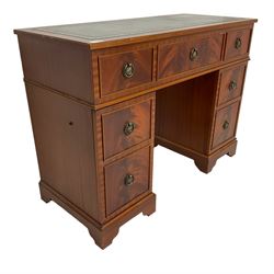 Music system in the form of a Georgian design twin pedestal desk, the reed moulded rectangular top hinges to reveal Garrard turntable with Dynatron Amplifier, fitted with speakers enclosed by two doors disguised as drawers, on bracket feet