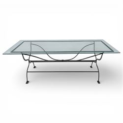 Late 20th century glass dining table, toughened glass top with rounded corners on a wrought metal designed base 
