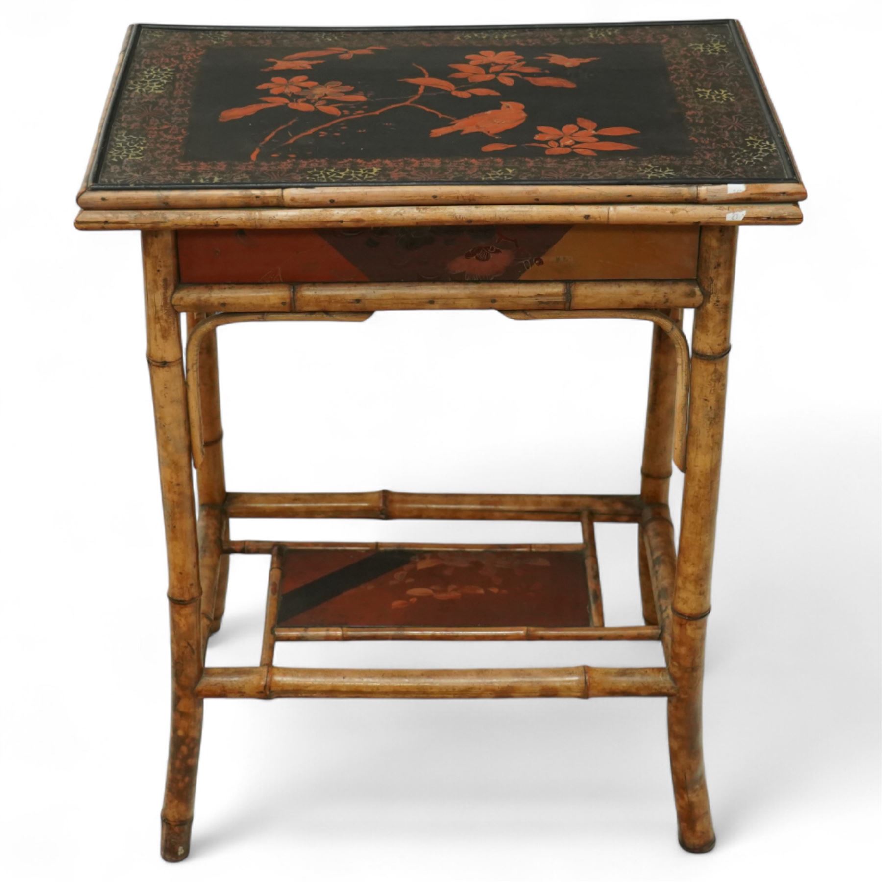 Late Victorian bamboo and lacquered card table, the top decorated with birds and floral sprays, hinged to reveal a baize playing surface, on bamboo effect legs with lacquered undertier