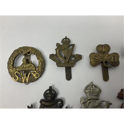 Fourteen cap badges of Irish interest including Royal Dublin Fusiliers inscribed to the slider 'From A. O'Connor 2nd Batt. Dec.2nd 1915', Connaught Rangers, South irish Horse Yeomanry, Inniskilling Fusiliers, Royal Irish Regiment etc; and seven Welsh badges including South Wales Borderers, Welsh Guards, 3rd Bn. Monmouthshire Regt. etc (21)