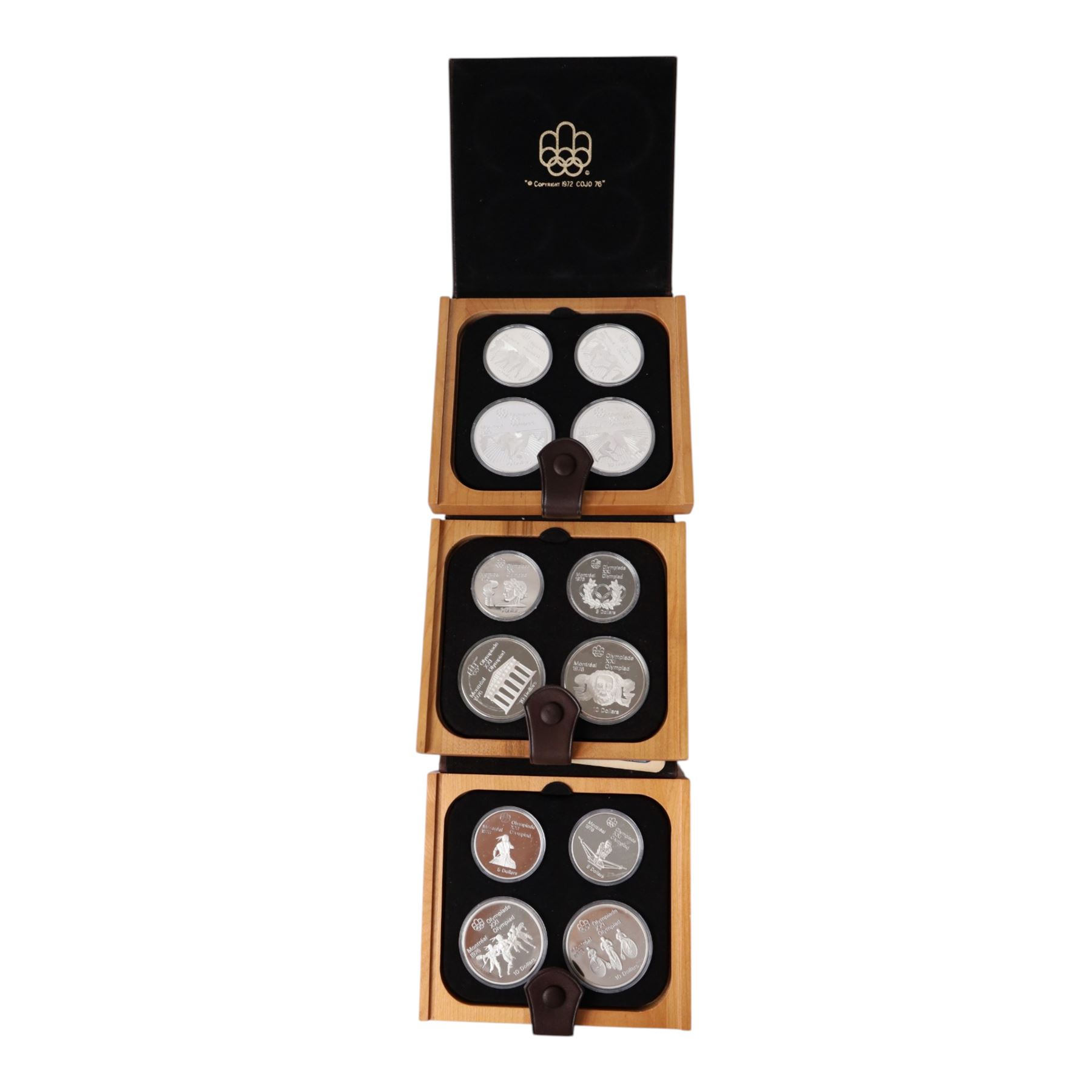 Seven Royal Canadian Mint 1976 'Montreal Olympics' silver proof four coin sets, each containing two five dollar and two ten dollar coins, each cased and boxed with certificates