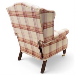 Laura Ashley - hardwood-framed wingback reclining armchair upholstered in checkered fabric, on turned and fluted front feet with brass cups and castors 
