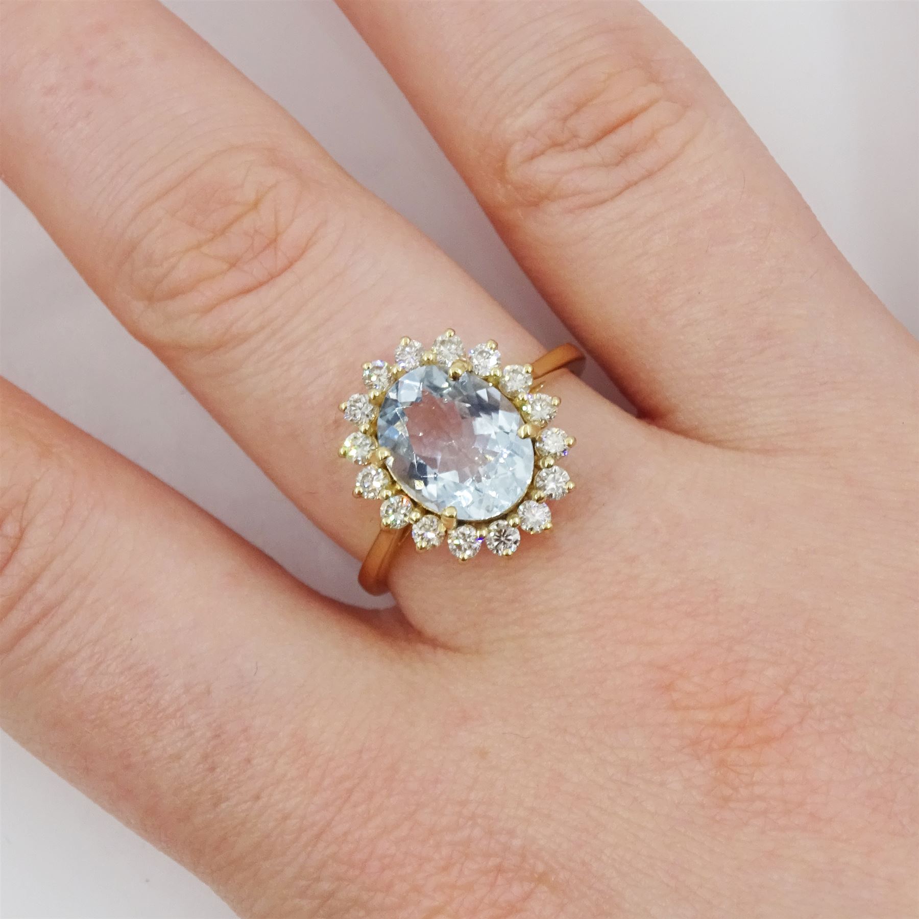 18ct gold oval cut aquamarine and round brilliant cut diamond cluster ring, stamped, aquamarine approx 1.90 carat, total diamond weight approx 0.50 carat