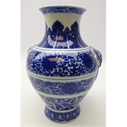  Late 19th/ early 20th century Chinese blue and white vase, ovoid body painted with concentric bands depicting crashing waves, scrolling lotus and stylized stiff leaves, elephant mask handles, the base with a six character Qianlong type seal mark, H26cm Provenance: acquired in the 1920's   