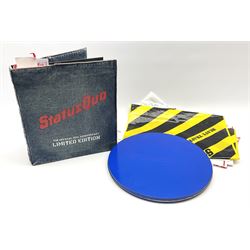 Status Quo: The Official 40th Anniversary Limited Edition book No.926/3000 with certificate signed by Rossi and Parfitt. Duplicate signatures by Rossi and Parfitt on pages within the book. Denim dustjacket; 'From The Makers Of ....' boxed set of three LP records in circular blue tin; and quantity of tour carrier bags