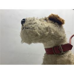 Tri ang - Pedigree Soft Toys - push along/ride-on dog as a wood wool filled plush Airedale terrier in red tubular frame with beech footrests and black rubber wheels; stitched Northern Ireland label in tact L60cm H61cm