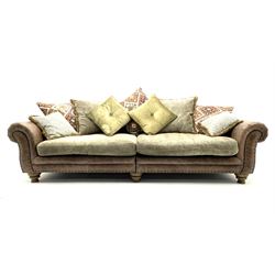 Alexander James - Grand two sectional sofa upholstered in studded leather and fabric, with contrasting kilim patterned scatter cushions, scrolling arms and turned front supports 