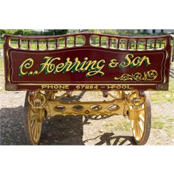 Advertising Trade Dray Wagon for C. Herring & Son, Hartlepool, Dated 1895 and Renovated 1975

An exceptionally decorative late Victorian horse drawn advertising trade dray, built by J. Herring of Hartlepool in 1895 and later renovated by C. Herring in 1975, as recorded by the painted inscription beneath the body. Finished in a striking cream and maroon livery with extensive hand painted signwriting, the wagon carries the name C. Herring & Son, Iron & Steel Processors, Hartlepool along its sides and rear panels. The wagon is fitted with a flat timber loading bed, twin shafts for a single horse, elegant spoked wooden wheels, iron bound tyres, rear headboard and traditional undercarriage with leaf spring suspension. Richly detailed scrollwork and lining throughout make this a particularly attractive example, suitable for collection, display, museum, promotional or coaching purposes.

Features

• Built by J. Herring, Hartlepool, 1895
• Renovated by C. Herring in 1975
• Original style hand painted advertising signwriting
• Flat timber loading platform
• Raised rear headboard with decorative pierced gallery
• Twin shafts for a single horse
• Wooden spoked wheels with iron tyres
• Traditional leaf spring suspension
• Extensive decorative lining and scrollwork throughout
• Attractive cream and maroon colour scheme
• Suitable for private collection, museum or display use

Dimensions:
Overall length: 560 cm
Body length: 300 cm
Width: 158 cm
Height: 150 cm

Wheel Diameters:
Front wheels: 76 cm
Rear wheels: 86 cm