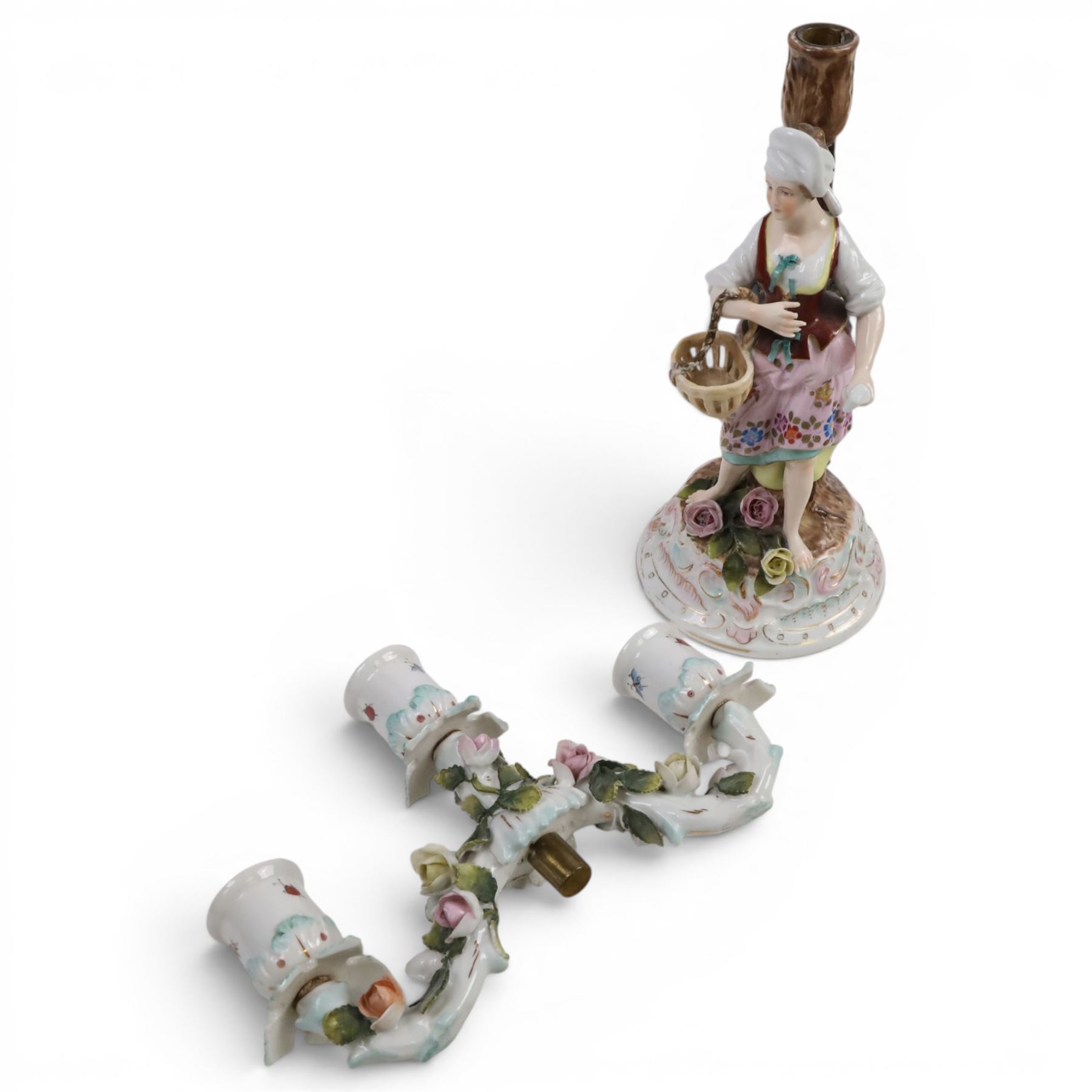 Pair of 19th Century German three-branch figural candlesticks, the figures each in floral dress against a tree, the branches decorated in relief with roses and the sconces painted with insects, H33cm 
