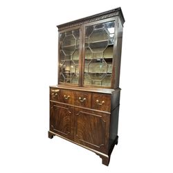 George III mahogany bookcase secretaire, dentil cornice over blind fret work frieze, enclosed by two astragal glazed doors, central secretaire drawer with fall front enclosing leather writing surface and small drawers, two flanking short drawers over double cupboard, on bracket feet
